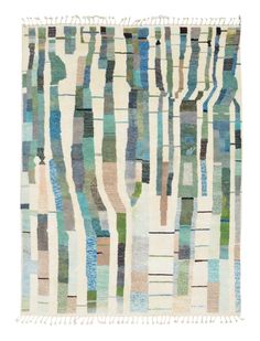 a multicolored rug with fringes on the bottom and an image of trees