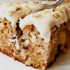 a close up of a piece of cake on a plate with a fork in it