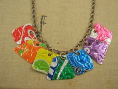 a multicolored necklace is hanging on a chain