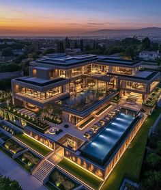 an aerial view of a modern mansion at dusk