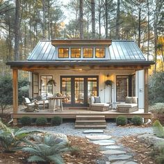 a small house in the woods with steps leading up to it