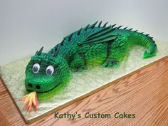 there is a cake made to look like a green dragon