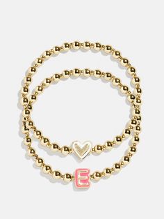 Give your mini the best of both worlds when you scoop up this two-in-one, super stackable bracelet set. The Initial & Heart Kids' Pisa Bracelet Set will feature the initial of your choosing crafted in vibrant enamel and flanked by gold ball beads. We paired each initial with a white enamel heart bracelet, ensuring your little's bracelet stack will be extra meaningful. READY TO GIFT: This item comes pre-packaged in a beautiful box. Please note: intended for children 3+ Heart Kids, Preppy Jewelry, Gold Bracelet Set, Gold Girl, Kids Bracelets, Beads Bracelet Design, Jewelry Accessories Ideas, Gold Bead Bracelets, Stacked Jewelry