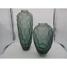 two green vases sitting next to each other