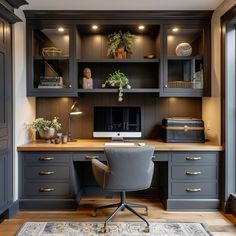 a home office with built in desk and cabinets