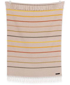 a beige and yellow striped blanket with fringes