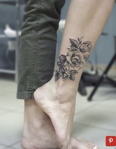 a woman's foot with a flower tattoo on her left ankle and right leg