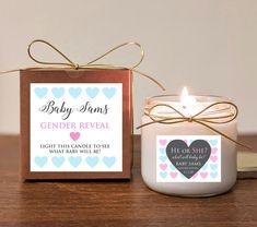 a baby shower candle next to a box with a label on it that says, gender reveal light this candle to see what baby will be