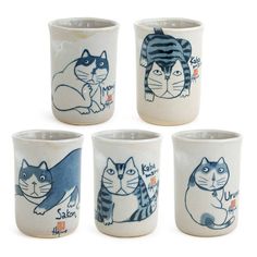 four ceramic cups with cats painted on them