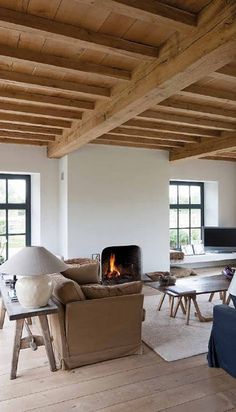 a living room filled with furniture and a fire place in the middle of it's walls