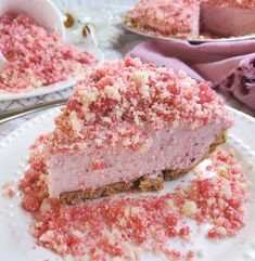 a piece of cake on a plate with pink sprinkles and crumbs