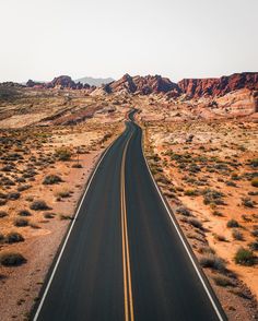 an aerial view of a road in the desert