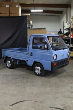 a small blue truck parked in a garage