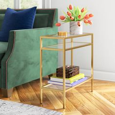 a living room with a green couch and some books on a small table in front of it