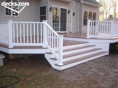 a white deck with steps leading up to it