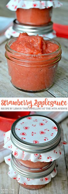 two jars filled with strawberry apple sauce sitting on top of a wooden table next to each other