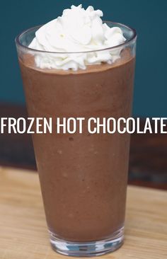 there is a chocolate drink with whipped cream in the cup on the table and text that reads frozen hot chocolate