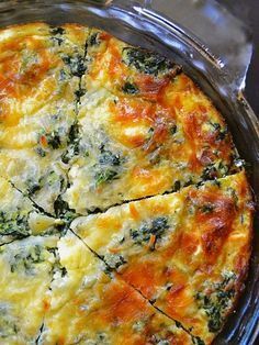 a quiche with cheese and spinach in a glass dish