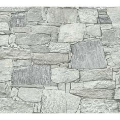 a stone wall that is made out of various types of rocks and has been used as a background