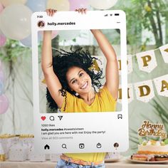 a woman holding up a birthday card with an image of her on it and balloons in the background