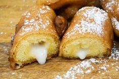 powdered sugar covered pastries on a wooden table