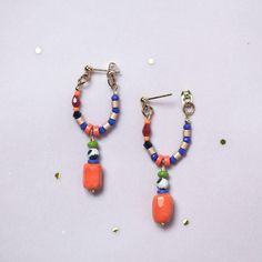 Statement Earrings, in Hot Orange and Blue, with a Hypoallergenic Stainless steel Stud post earring plated with a 18K gold. We use this material to ensuring your comfort and safety.  They were designed with natural Dalmatian Jasper, carefully selected Czech glass beads and  Crystal beads ,creating a unique combination.  Please note that the beads used in these earrings may vary slightly, adding to their unique charm.  ITEM DETAILS:  *Total length 45 mm from the post until the end of the pendant  *Earring post are lead and nickel free. I will prepare a pair of earrings for you, please note that they are made to order, and it could take a few days to process. They will came nice packaged in a Velvet Bag and a small Box, to protect them  during the shipment. Do you like them, but want to chec Stud Beaded Earrings, Trendy Small Hoop Earrings With Colorful Beads, Trendy Hoop Earrings With Dangling Beads, Trendy Small Hoop Earrings With Dangling Beads, Trendy Colorful Beaded Hoop Earrings For Gifts, Hoop Earrings With Dangling Beads Gift, Everyday Multicolor Dangling Beads Earrings, Trendy Dangle Jewelry With Colorful Beads, Trendy Colorful Beads Dangle Jewelry