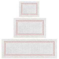 two white towels with pink borders on top of each other in front of a white background