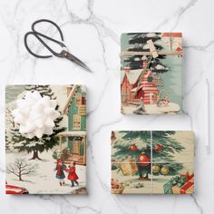 wrapping paper and scissors on a marble surface with christmas scenes, snowflakes and trees