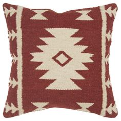 a red and white pillow with an arrow design on the front, sitting on a white background