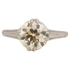 an old mine cut diamond ring with two tone gold and white diamonds in the center