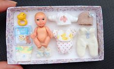 a baby doll is in a box with other toys