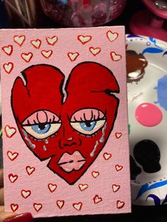 a painting of a red heart with tears on it