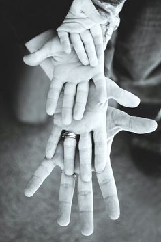 two hands reaching out towards each other with one hand holding the other's finger