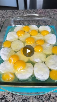 an image of fried eggs in a glass dish on a counter top with a video play button