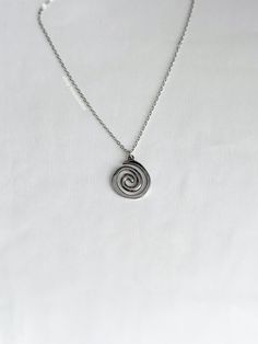 A fun, vortex necklace featuring a spiral charm on a 2mm rolo chain. An absolute essential in every jewelry collection. Our chains are 100% stainless steel and hypoallergenic so they won't rust, tarnish, or turn your neck green. - Water resistant - Lobster clasp closure - Pendant size: ~22mm - Stainless steel chain + pendant - Select desired size at checkout Swirl Necklace, Spiral Necklace, Rolo Chain, Belly Rings, Birthday Present, Chain Pendants, Stainless Steel Chain, Silver Necklaces, Ring Earrings