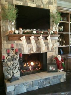 a living room with a fireplace decorated for christmas