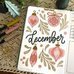 a notebook with the word december written on it next to some pens and other items