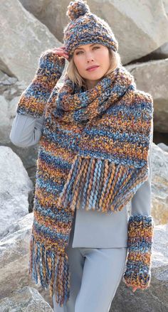 a woman wearing a multicolored knitted scarf, hat and leggings