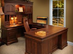 an office with a desk, chair and lamp in front of a large open window