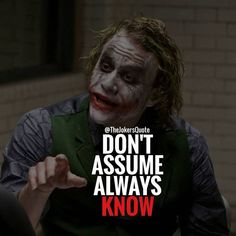 the joker is pointing at something with his hand and saying, don't assume always know