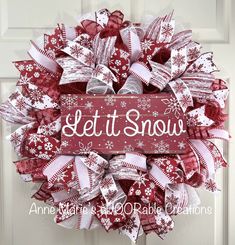 a red and white wreath that says let it snow