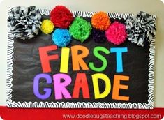 the first grade sign is decorated with pom - poms and zebra print paper