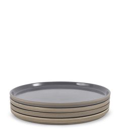 four grey plates stacked on top of each other