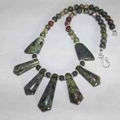 Handcrafted Gemstone Necklace. Materials: 40x14 Mm - 22x15 Mm And 8 Mm Round Dragon Blood Jasper Beads; Crystal Beads; Silver Plated Findings. It Has A Hook Clasp. Length: 18" Colors: Green, Red Only One Made. Fan Jewelry, Dragon Blood, Dragons Blood, Colors Green, Silver Plated Necklace, Hook Clasp, Jasper Beads, Red Jasper, Gemstone Necklace