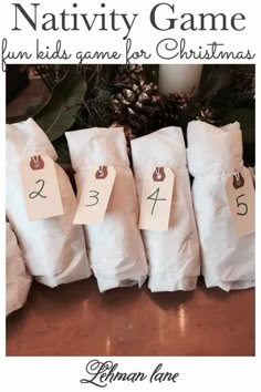 the nativity game for christmas is shown in white paper bags with numbers on them