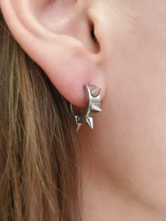 Spike hoop earrings, Spiked ear hoops, Punk Emo Rock Rebel earrings, Gothic spike earrings, Stainless steel dainty spike hoops TO SEE ALL ITEMS IN OUR SHOP, CLICK HERE: https://www.etsy.com/shop/thefandomempress ** 9mm hoops ** Unisex ** Sold in pairs - 2 earrings  ** Hypo-Allergenic ** Stainless Steel ** 6 spikes all around hoop ** Light and comfortable Show of your style, whether it is punk, rock, emo, goth, rebel or just to add a little flare to your look! GUARANTEE If you are not satisfied in any way, message us first and we will make it right. PROCESSING We work hard to prepare and ship all orders within 1 - 3 business days after receiving it. SHIPPING  - CANADA: 3 - 10 business days - USA: 5 - 15 business days ♥BUY WITH CONFIDENCE♥ Please know that customer service is very important Spiked Hoop Earrings, Emo Earrings Aesthetic, Masc Earrings, Spikes Aesthetic, Spiked Earrings, Emo Earrings, Punk Piercings, Alternative Earrings, Grunge Earrings