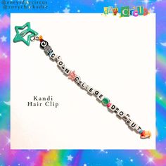 the name kandi hair clip is made out of beads and letters that spell out words