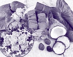 a plate full of food sitting on top of a table next to some leaves and flowers