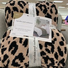 an animal print blanket is wrapped up on a chair with a price tag attached to it