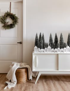 a white cabinet with christmas trees on top